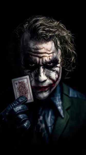 Joker Holding Playing Card Wallpaper