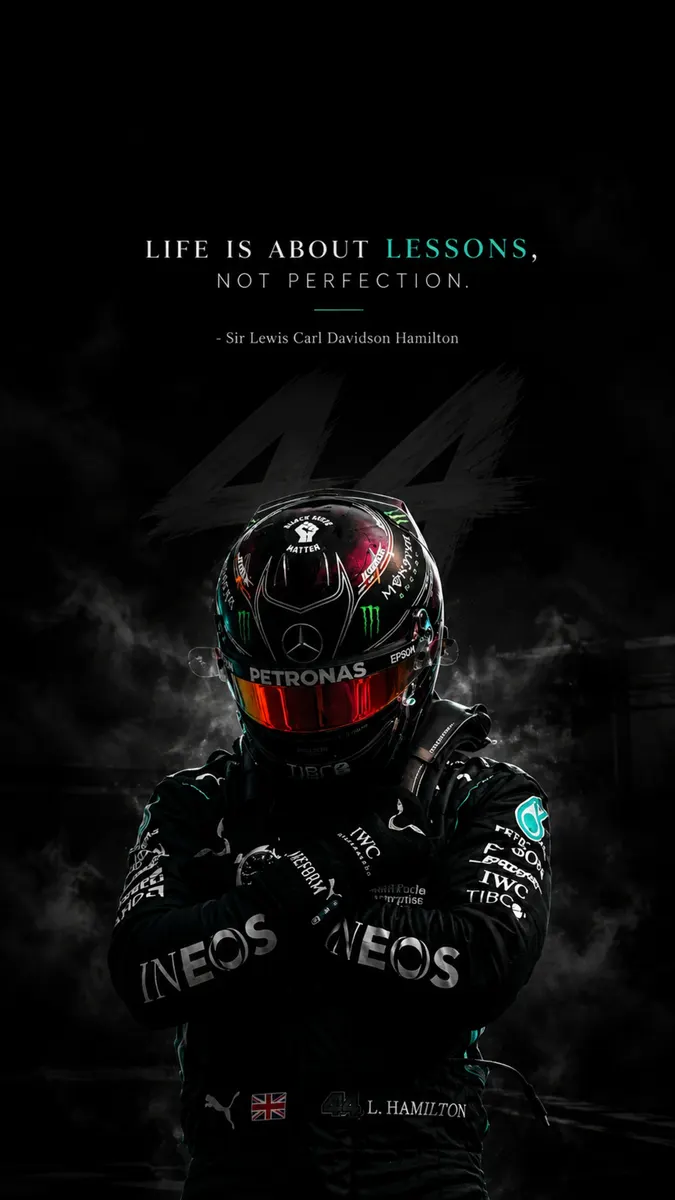 Lewis Hamilton wearing a black racing helmet and team suit with the number 44 visible in the background