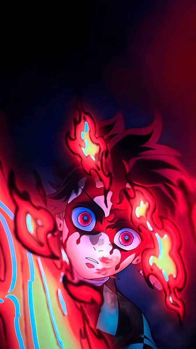 Tanjiro Kamado mit intensiven Augen und roten Flammen, die sein Gesicht und Haar in einer dunklen Szene umgeben